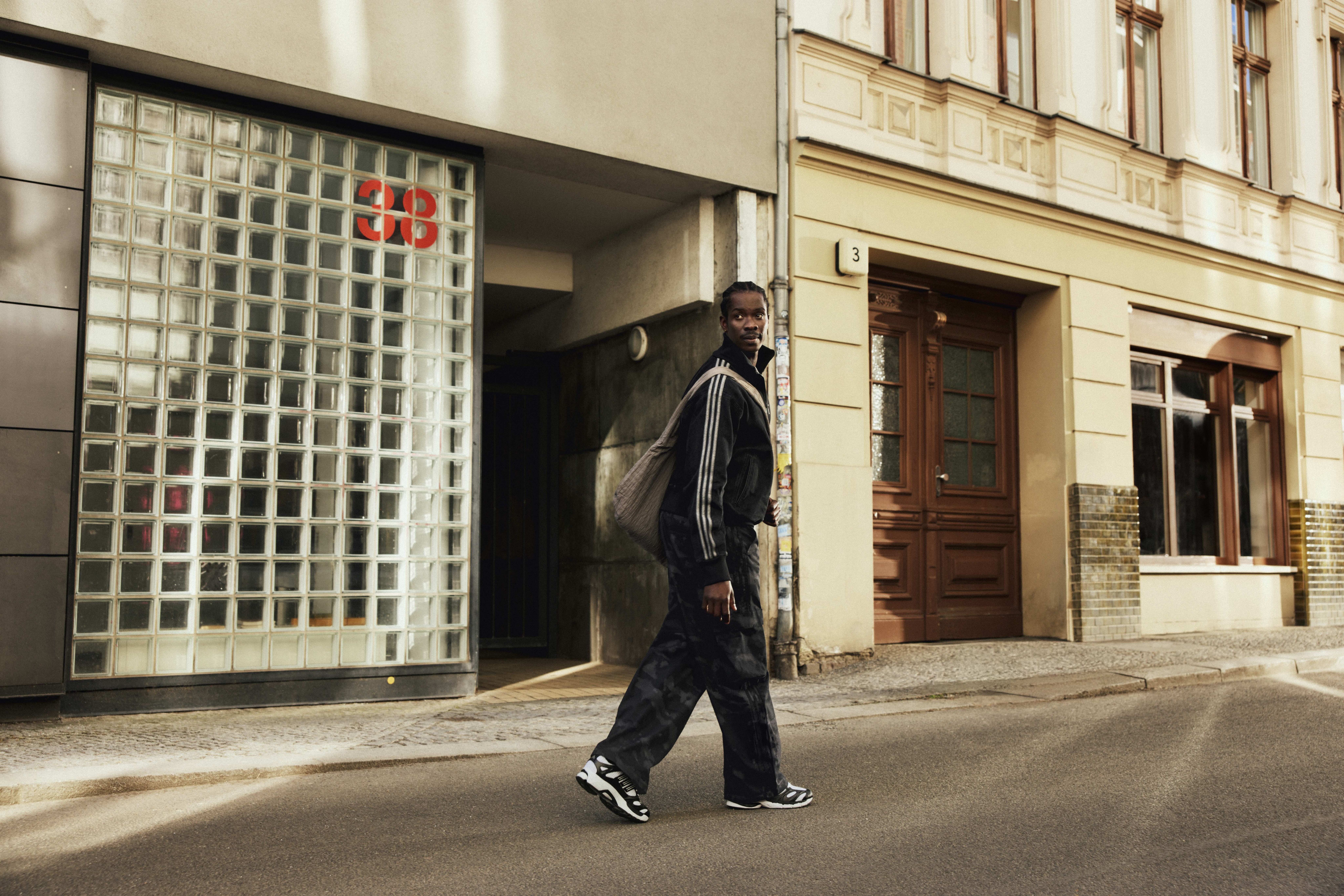 A model wearing an ADIDAS ORIGINALS streetwear look
